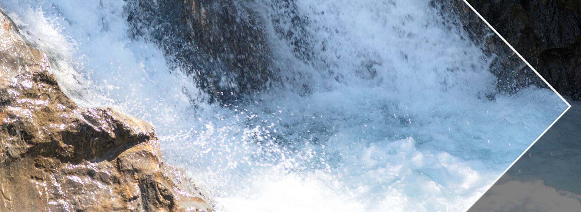 Water flowing over rocks in a fast-flowing stream.
