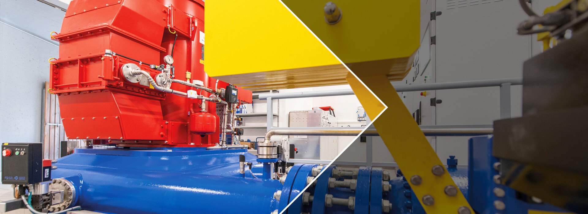 Hydroelectric power plant with red and blue metal casing and yellow component in a technical environment.